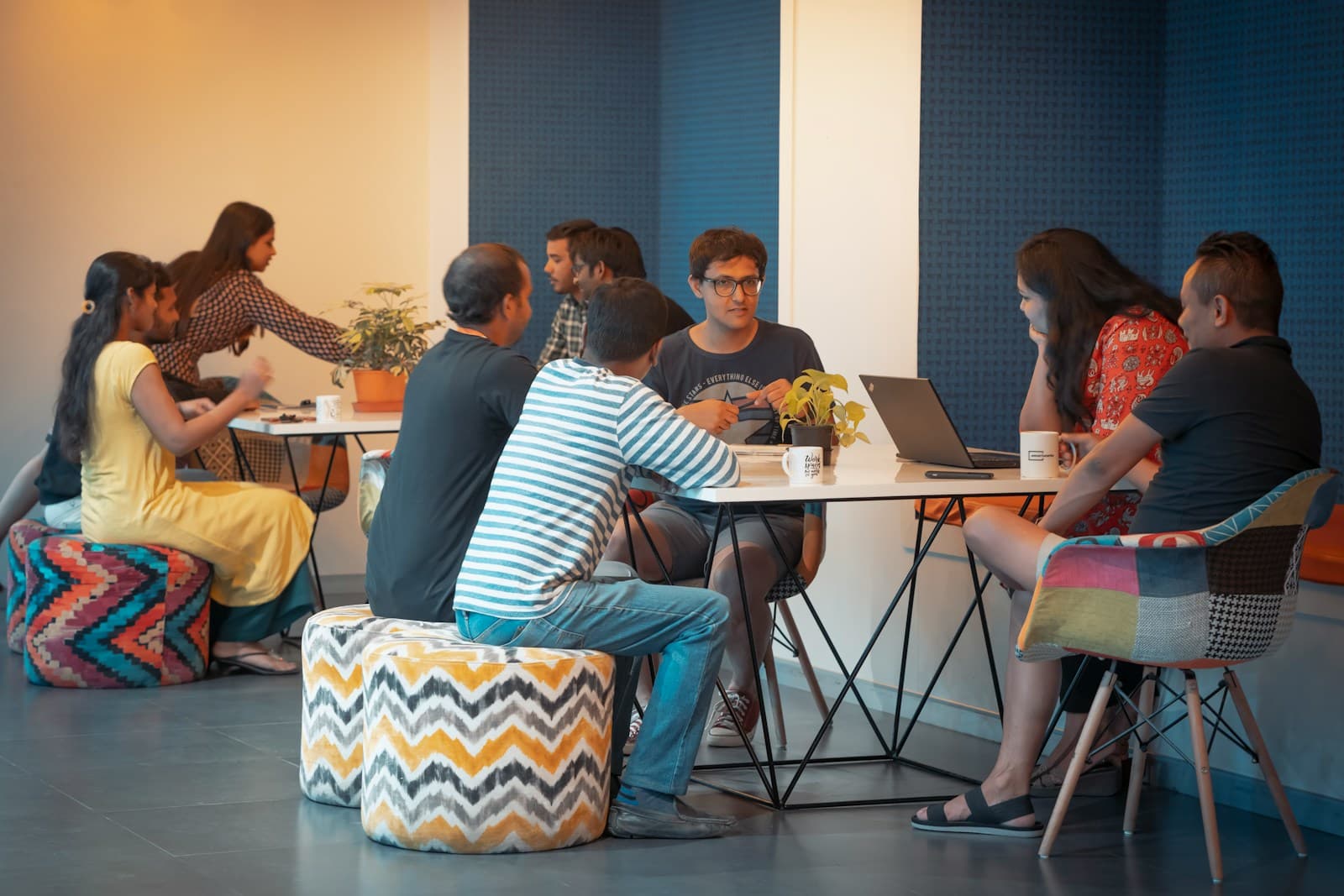 Colleagues working together around a table in an open office